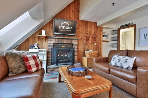 Welcoming living space with an electric fireplace and seating arranged for conversation, games, or relaxing after a day on the mountain.