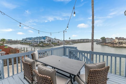 Enjoy waterfront dining on this scenic deck with string lights creating perfect ambiance for your memorable meals.