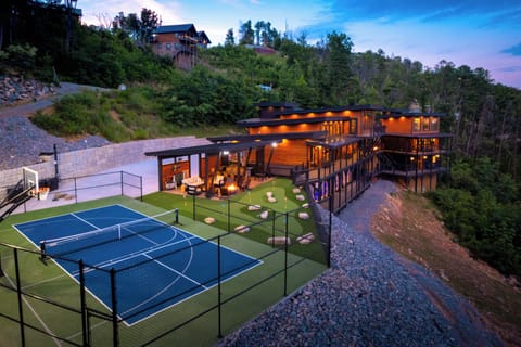 Outdoor recreation area with court, putt putt, pavilion, firepit, dining & grill