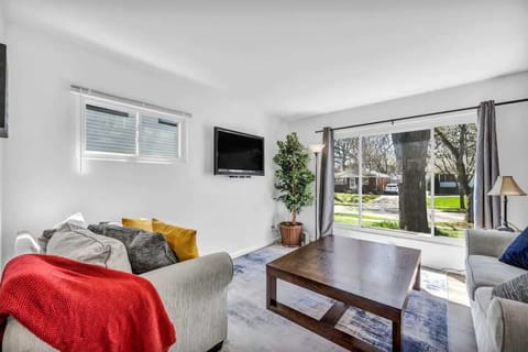 Airy living room opening to the outdoors, blending indoor comfort w/ natural light.