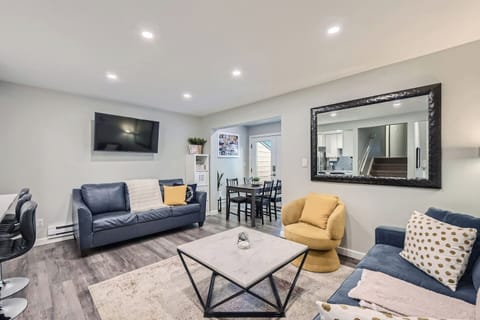 2 couches, 1 chair. Pull over the dining chairs or stools from the island to cozy up the entire group!