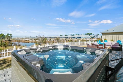 Fully fenced backyard. Hot tub, seating, and coastal vibes