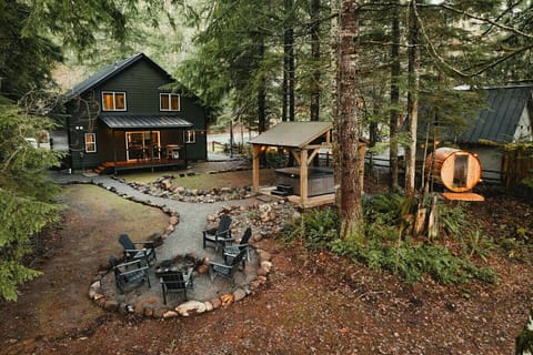 Backyard - Step into nature with backyard access to the firepit, hot tub, barrel sauna, a small creek and forested scenery!