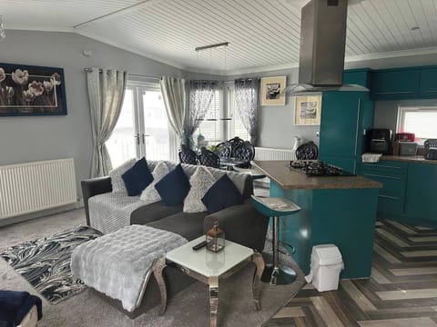 Bright living room with lots of seating French doors to decking 