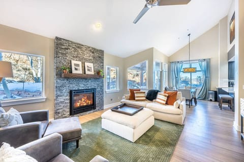 Cozy up next to the stone fireplace in our open-concept, Park City living room with soaring vaulted ceilings.