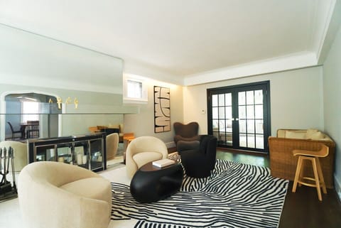 Modern furnishings and a striking mirror create a bright, inviting spot to unwind or catch up with the group.