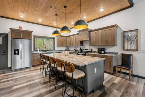 Whip up breakfast with a view—this spacious kitchen is fully equipped and framed by scenic forest through the picture window above the sink.