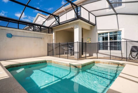 Welcome to your private oasis featuring a sparkling pool and a sleek screened enclosure for ultimate comfort. Enjoy the bright, airy layout with large windows, ideal for relaxing on the patio and unwinding in the inviting waters.