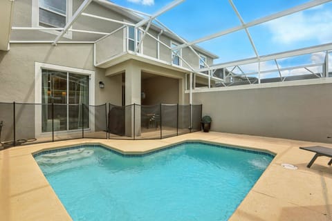 Step into your private oasis featuring a refreshing pool framed by a spacious lanai, ideal for sunbathing or enjoying a book. The clean lines and light-colored tiles create a bright, airy atmosphere, perfect for relaxation.