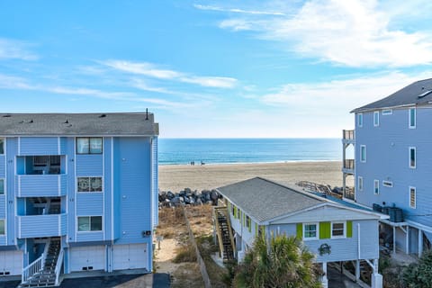 Colorful beach houses create a charming coastal community with direct access to pristine sandy shores and endless ocean views.