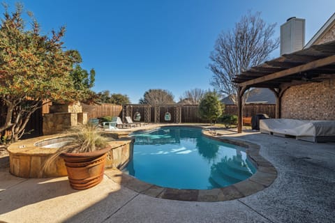 Backyard oasis with private pool, hot tub, and fireplace.