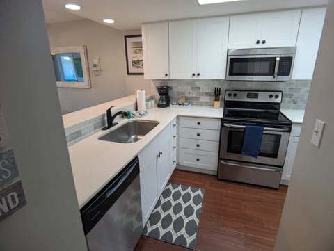 Kitchen with solid surfaces, stainless appliances, coffee station and much more