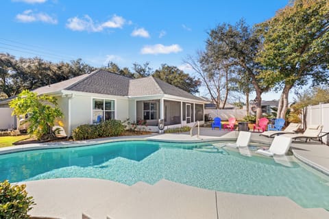 Beautiful outdoor oasis with heated saltwater pool, sun loungers, & games.