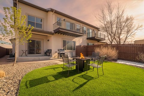 Welcome to Westland Base! This modern mountain retreat features a private, fully fenced backyard with a manicured turf lawn and a cozy fire pit area for evening relaxation.