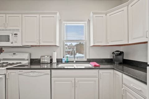 Clean, bright workspace with ample counter space, modern appliances, and thoughtful touches throughout.