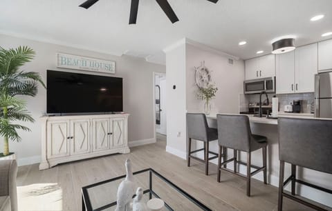 Living room featuring brand new smart TV and smart thermostat.