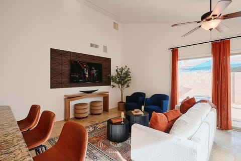 Main living area featuring cozy furnishings, a Smart TV, and access to the backyard.