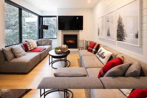View of the living room with wood burning fire place