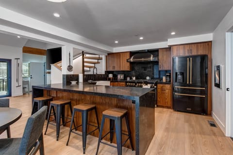 Your gourmet kitchen awaits with rich wood cabinetry, sleek granite counters, and stainless steel appliances perfect for culinary adventures together.