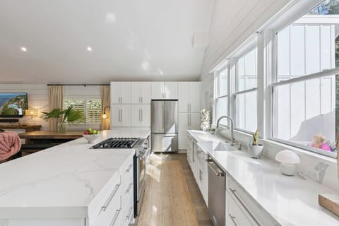 Your gourmet kitchen awaits with marble counters, stainless appliances, and sunlit windows perfect for morning coffee rituals.