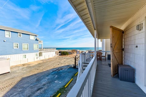 Beachfront balcony with ocean views and convenient outdoor seating for your perfect coastal getaway.