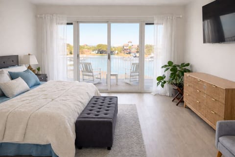 Wake up to water views in this bright modern bedroom with king-size bed