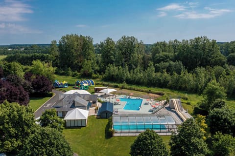 Family fun awaits! With colorful inflatable attractions and a sparkling pool, there's endless joy and laughter at Camping La Citadelle.