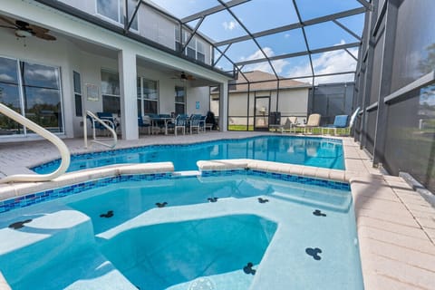 Private screened-in pool with seating and outdoor relaxation area