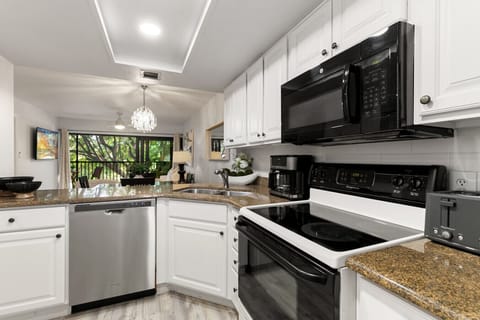 The kitchen is highlighted by beautiful granite counter tops and modern appliances.