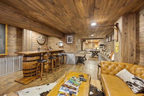 The lounge and bar invite everyone to gather, play games, and unwind in a warm, cozy atmosphere.