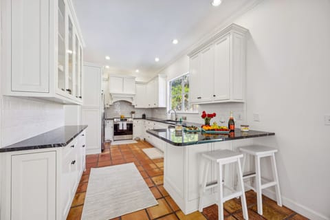 Kitchen: The kitchen is fully stocked with pots, pans, plates, cups, and utensils - Everything you need for home cooked meals.