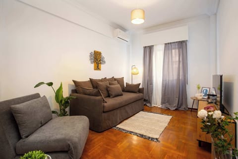 Bright living room with comfortable sofa and TV, great for relaxing after a day out.