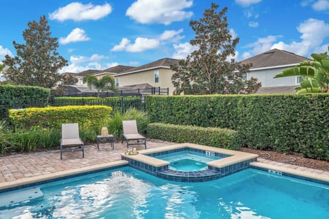 Relax by the private pool & spa, surrounded by lush hedges and sunny patio seating