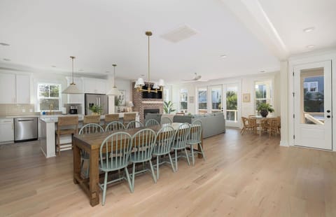 Your open-concept kitchen flows into a dining area where everyone gathers around the farmhouse table for memorable meals together.