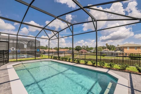 Step outside to enjoy your private pool, surrounded by a sleek screen enclosure that lets in natural light while keeping bugs at bay. The inviting teal water sparkles under the sun, making it a refreshing oasis on warm days.