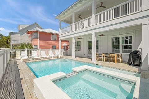 Dive into your private oasis with sparkling pool, hot tub, and shaded dining area perfect for poolside meals.