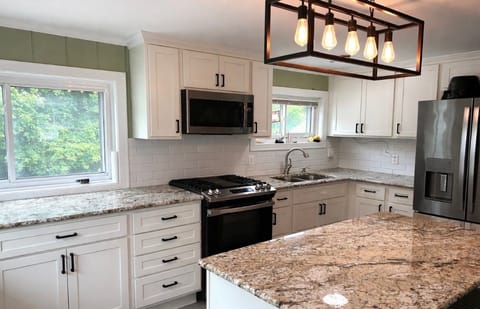 Fully stocked kitchen with mini coffee bar, spices, cookware, additional seating