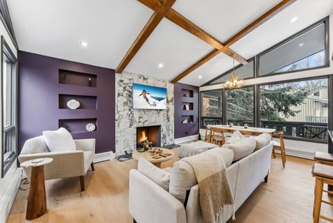 Stunning living area with vaulted ceilings, huge windows, and smart TV