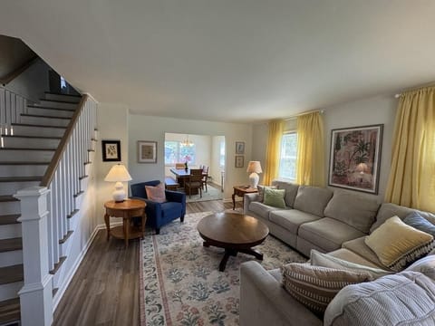Bright, open living room with cozy seating and a relaxed coastal feel.