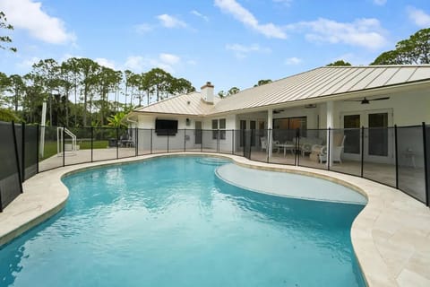 Enjoy the saltwater pool while enjoying the outside TV and lounging area.