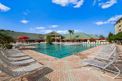 A tranquil pool area with comfortable seating and vibrant umbrellas for sun protection.
