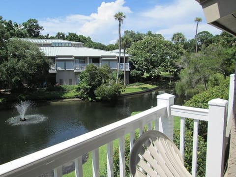 Take in peaceful views from your private balcony overlooking lush resort grounds.