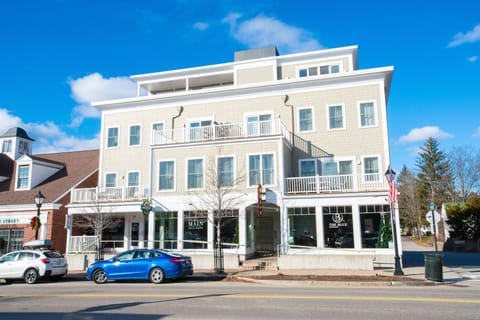 Bathed in bright sunlight, the stylish facade showcases its modern elegance amidst the timeless coastal culture of Kennebunk.