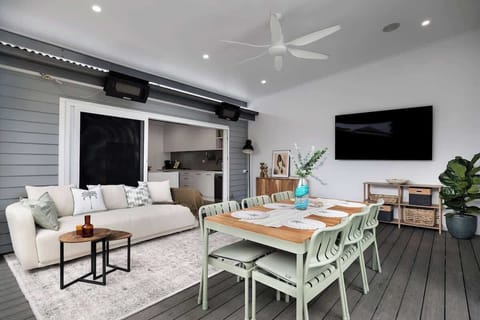 Amazing outdoor living area that flows from the kitchen. Here you have dining, lounge, TV, fan, heating, wind down blinds so you can adjust to weather conditions. 