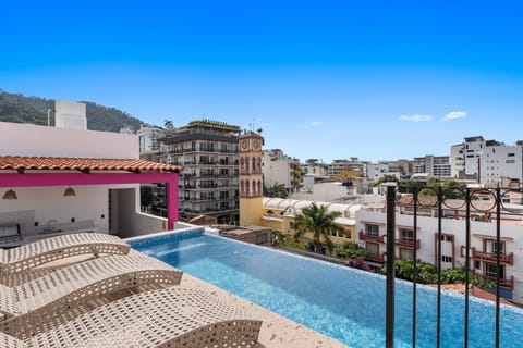 Infinity Pool - Shared Pool & Lounge Chairs With City View and Little Bit of Ocean