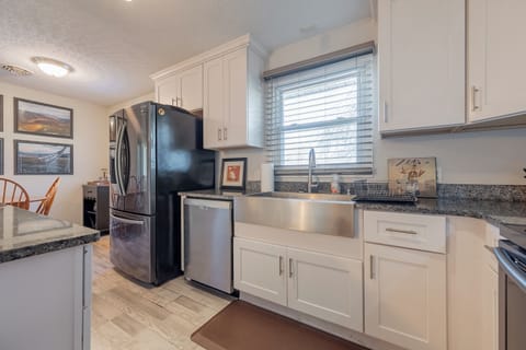 Bright and functional kitchen with modern appliances, granite counters, and a spacious farmhouse sink.
