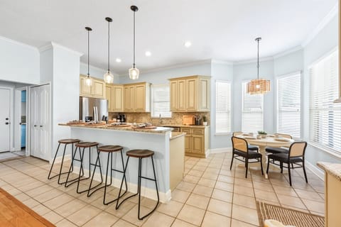 Bright, open kitchen with generous island seating and cozy breakfast nook