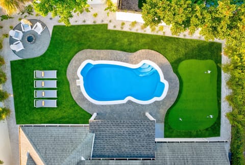 Resort-style backyard with private pool, putting green, and fire pit — designed for full relaxation
