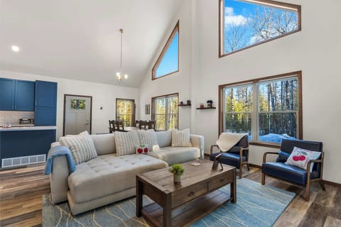 Modern forest retreat surrounded by golden autumn trees and natural landscape, offering peaceful seclusion.
