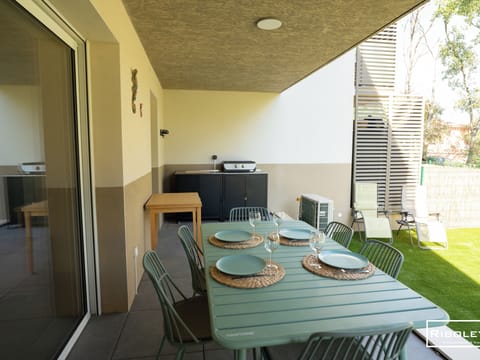 Shaded terrace with garden furniture, electric plancha grill... 